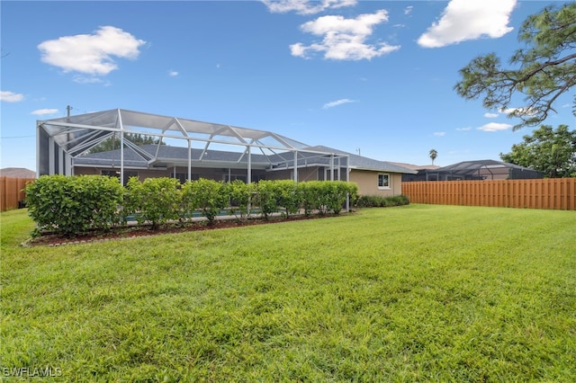 view of yard with glass enclosure