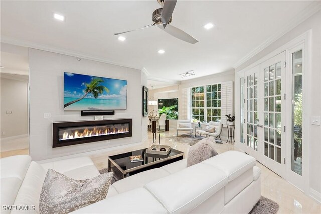 living room featuring ceiling fan and crown molding