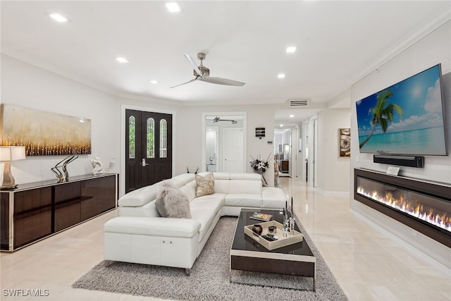 living room featuring crown molding and ceiling fan