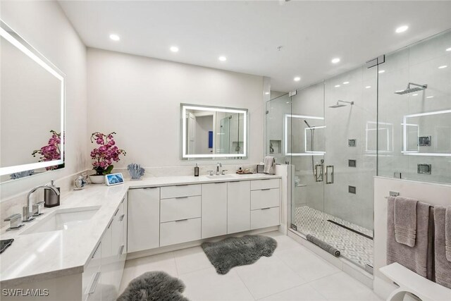 bathroom featuring tile patterned floors, vanity, and a shower with shower door