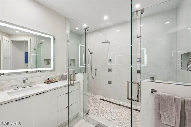 bathroom with vanity, tile patterned flooring, and a shower with door