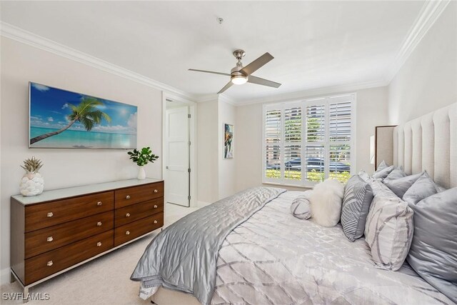 carpeted bedroom featuring ceiling fan and ornamental molding