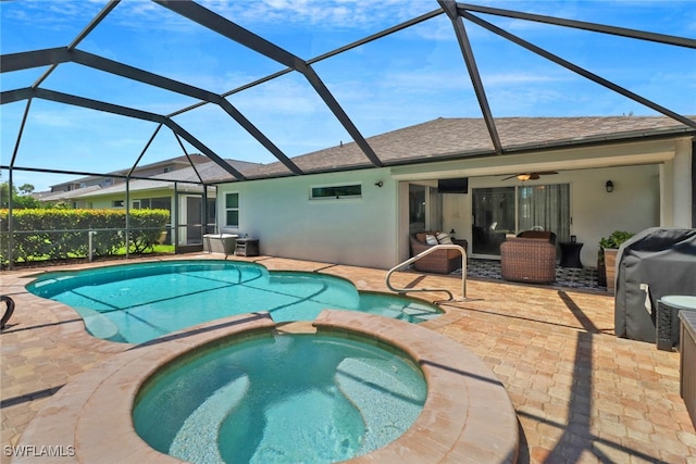 view of pool featuring a grill, an in ground hot tub, a lanai, a patio area, and ceiling fan