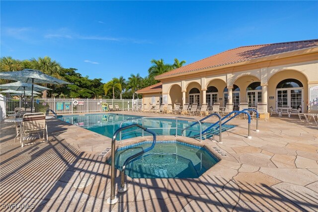 view of pool featuring a community hot tub and a patio area