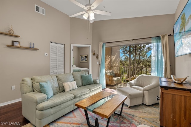 living room featuring high vaulted ceiling, ceiling fan, wood-type flooring, and a healthy amount of sunlight