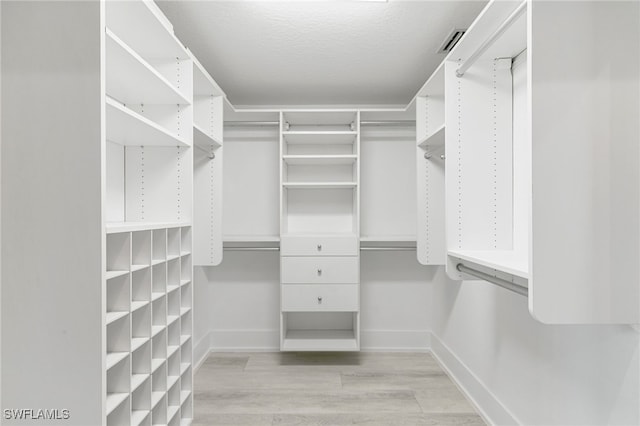 spacious closet featuring light hardwood / wood-style flooring