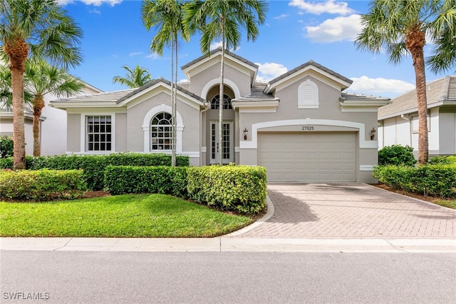 mediterranean / spanish-style house with a garage