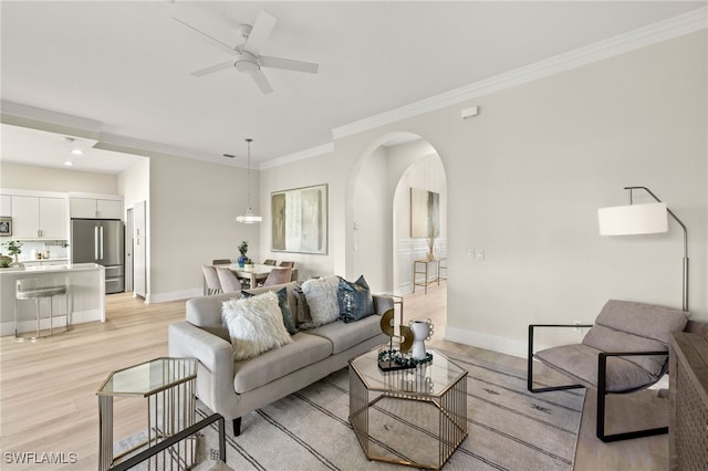 27025 Shell Ridge Cir, Bonita Springs, FL 34134 - living area with baseboards, ornamental molding, ceiling fan, arched walkways, and light wood-style floors