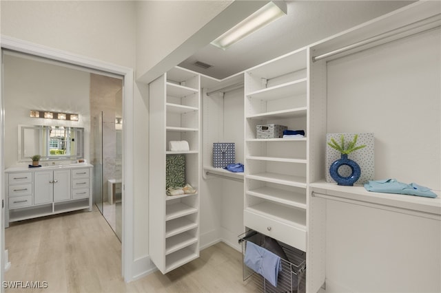 walk in closet featuring light hardwood / wood-style flooring