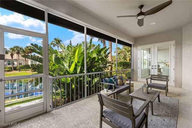 sunroom with french doors, ceiling fan, and washer / dryer