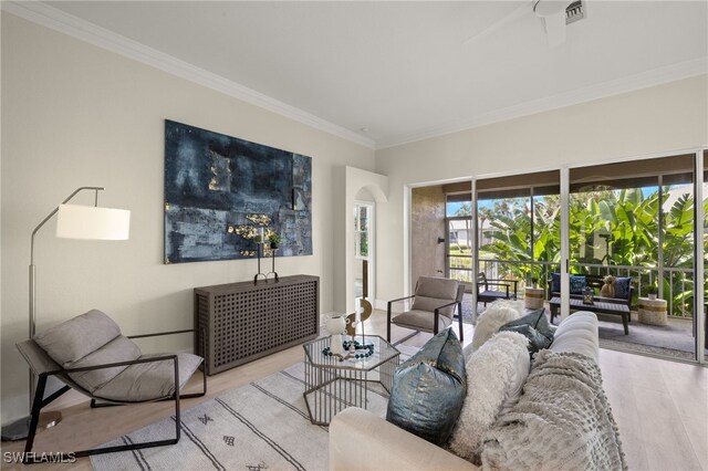 living room featuring ornamental molding and light hardwood / wood-style floors