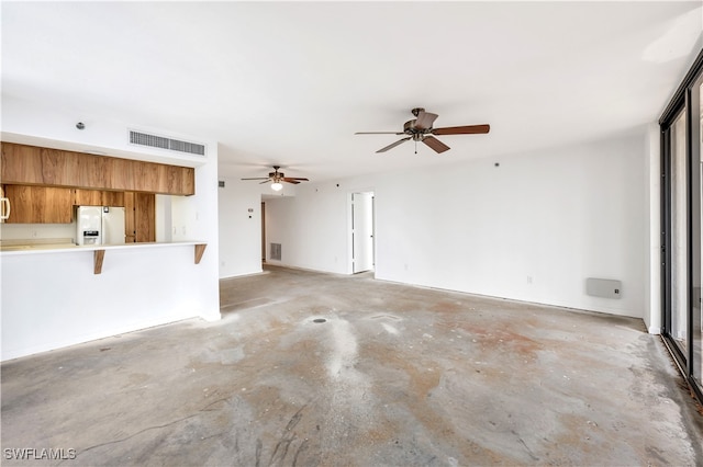 unfurnished living room featuring concrete floors and ceiling fan