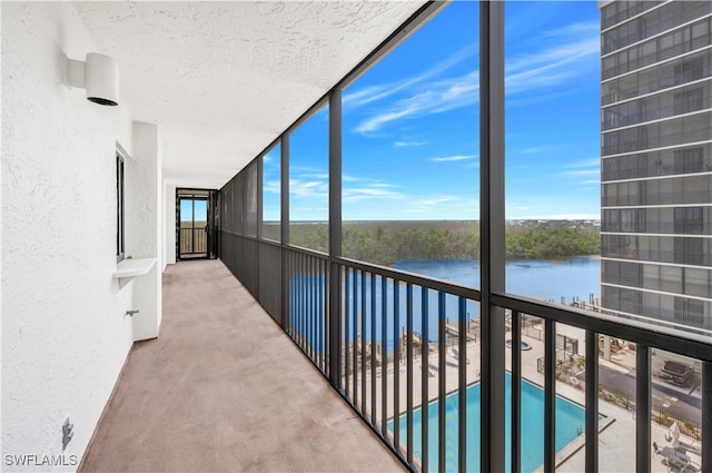 unfurnished sunroom featuring a water view