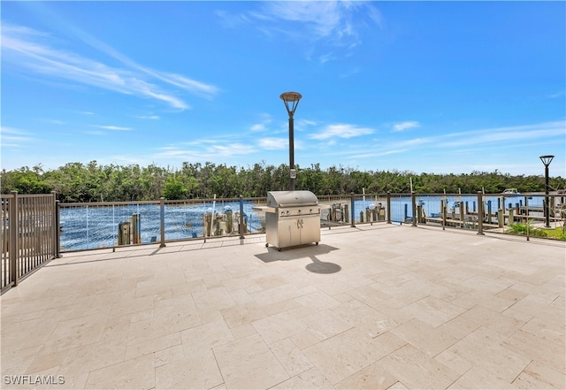 view of patio / terrace featuring grilling area and a water view