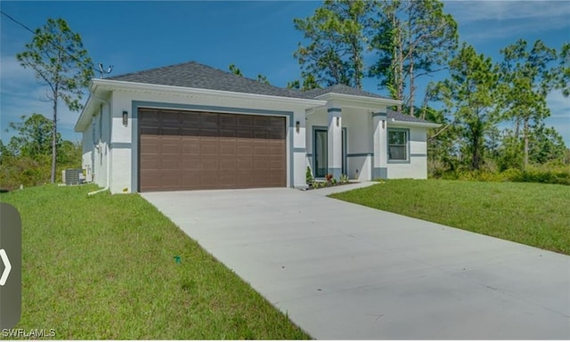 view of front of house featuring a garage, central air condition unit, and a front yard