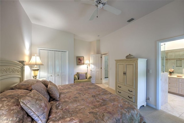 bedroom with visible vents, connected bathroom, light colored carpet, a closet, and a ceiling fan