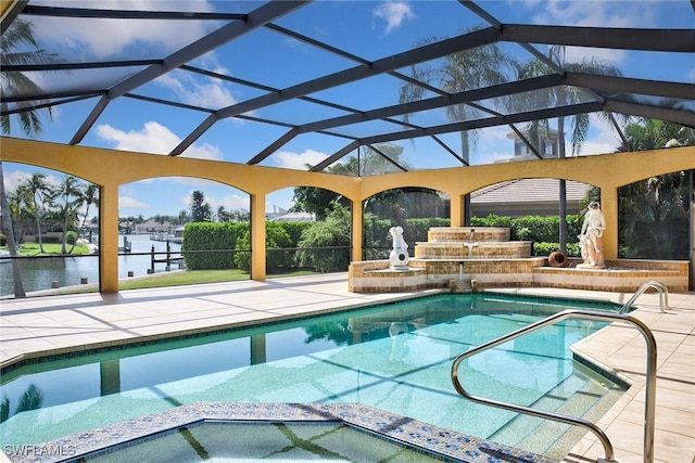 view of swimming pool featuring glass enclosure, a patio, a water view, and a pool with connected hot tub