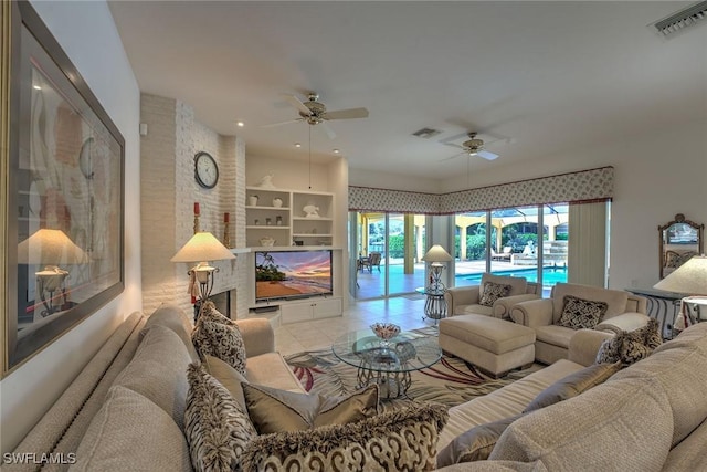 tiled living room with visible vents and ceiling fan