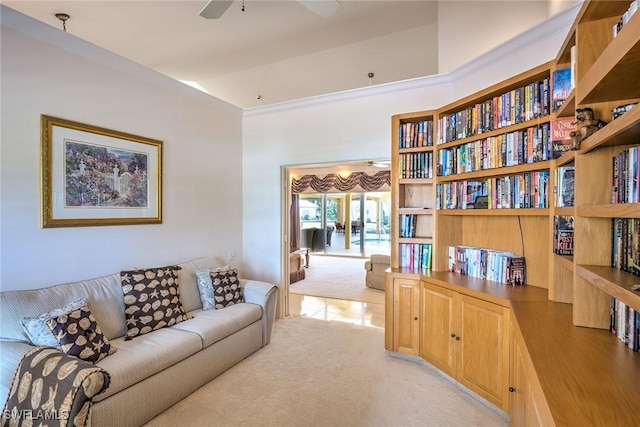 living room with a ceiling fan, vaulted ceiling, and light colored carpet