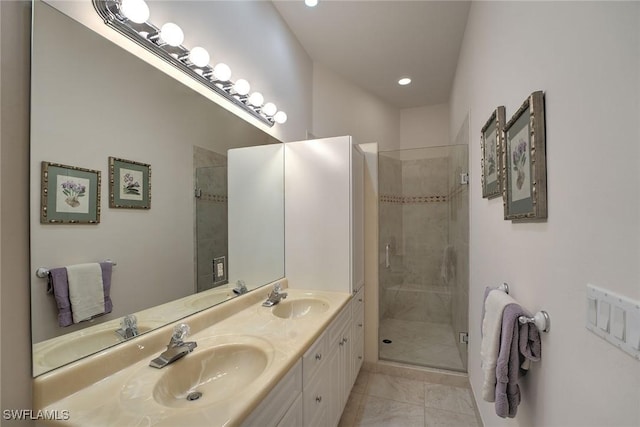 bathroom with double vanity, a stall shower, and a sink