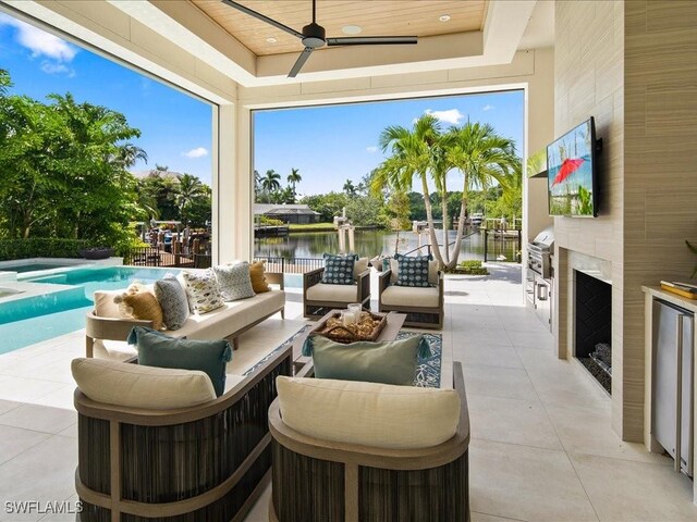 interior space featuring wood ceiling, an outdoor fireplace, ceiling fan, and a wealth of natural light