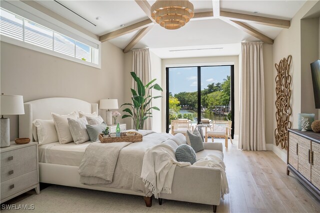 bedroom featuring vaulted ceiling with beams, a notable chandelier, and light wood-type flooring