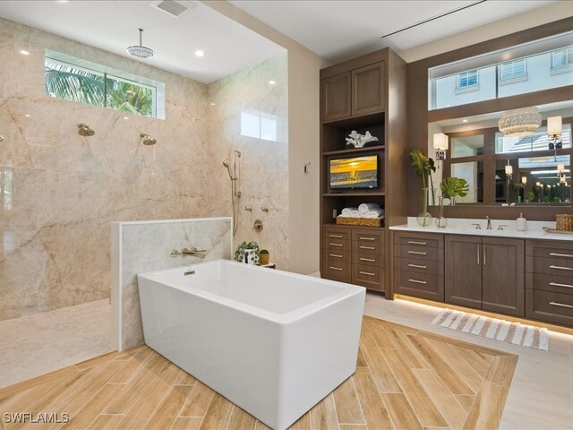 bathroom with vanity, plus walk in shower, and tile walls