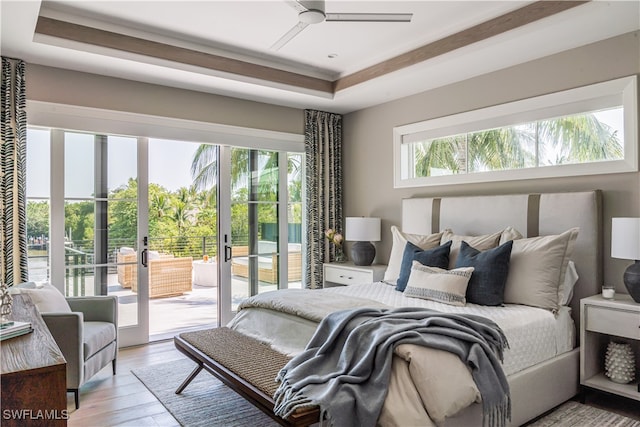 bedroom featuring multiple windows, access to exterior, ceiling fan, and french doors