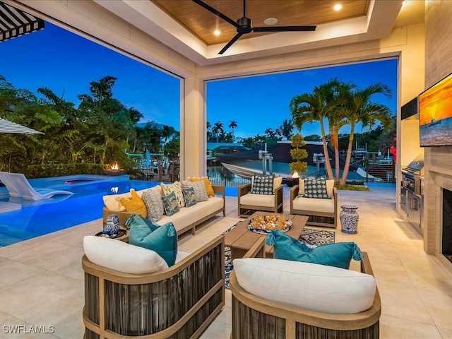 view of patio with an outdoor living space, exterior kitchen, a pool, and ceiling fan