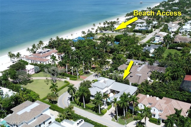 birds eye view of property featuring a water view and a view of the beach