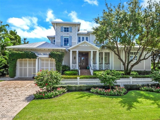 view of front of home featuring a garage and a front lawn