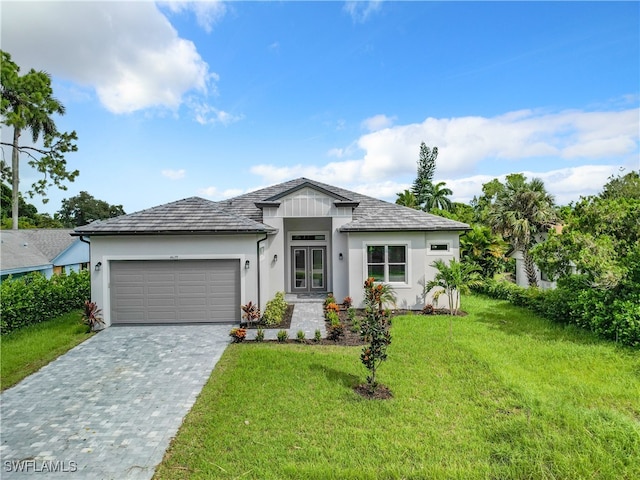 view of front of home featuring a garage and a front lawn