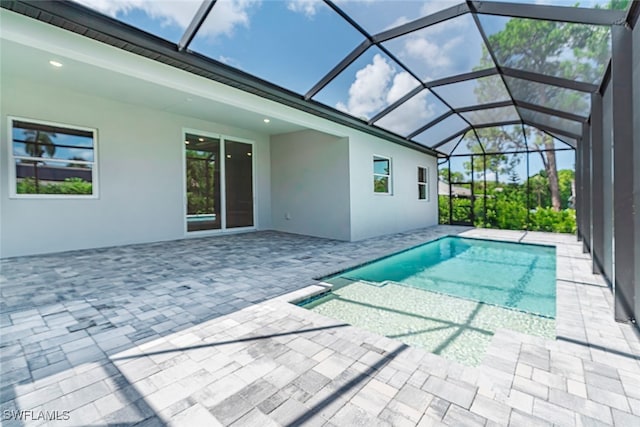 view of pool featuring a patio and glass enclosure