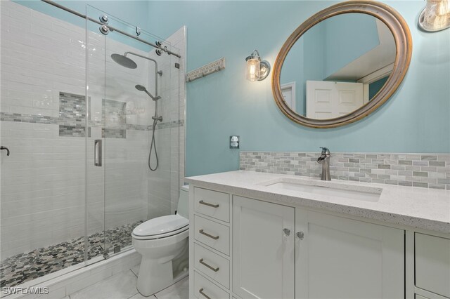 bathroom featuring a shower with shower door, backsplash, toilet, and vanity