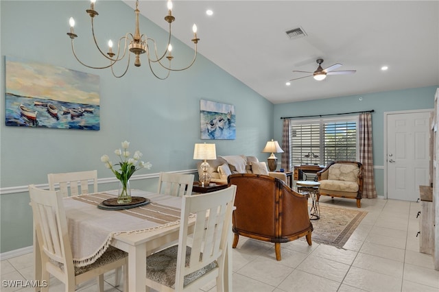 tiled dining area featuring lofted ceiling and ceiling fan with notable chandelier