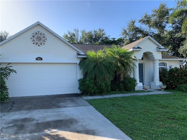 single story home with a front yard and a garage