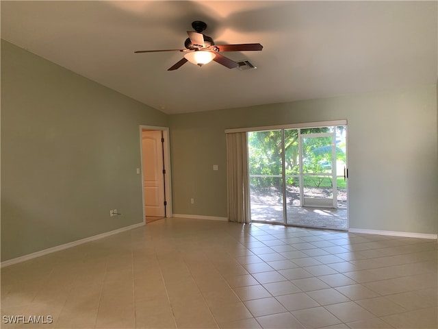 tiled spare room with vaulted ceiling and ceiling fan