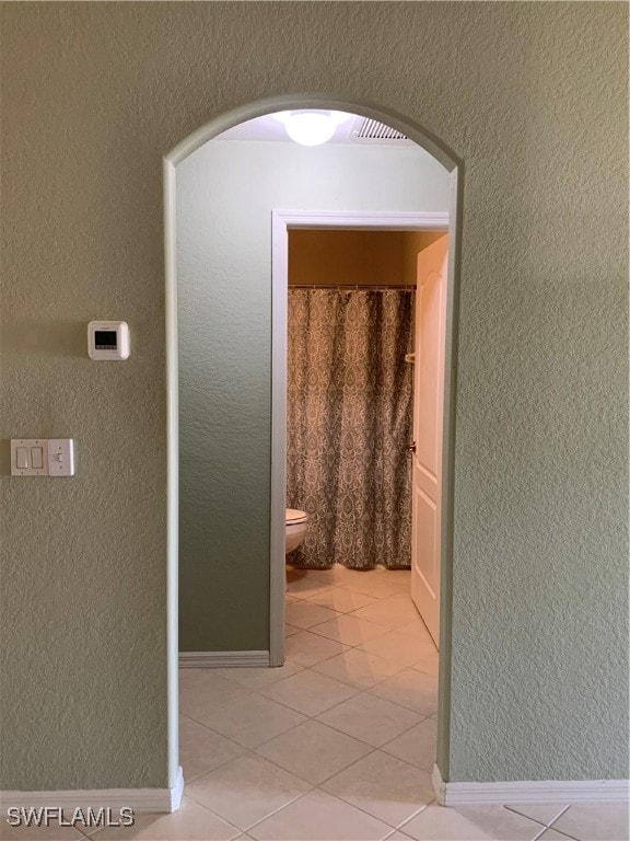 corridor with light tile patterned floors