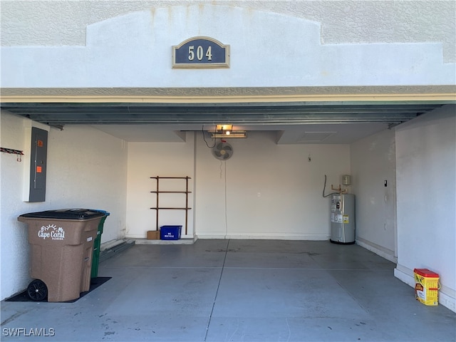 garage featuring electric panel and water heater