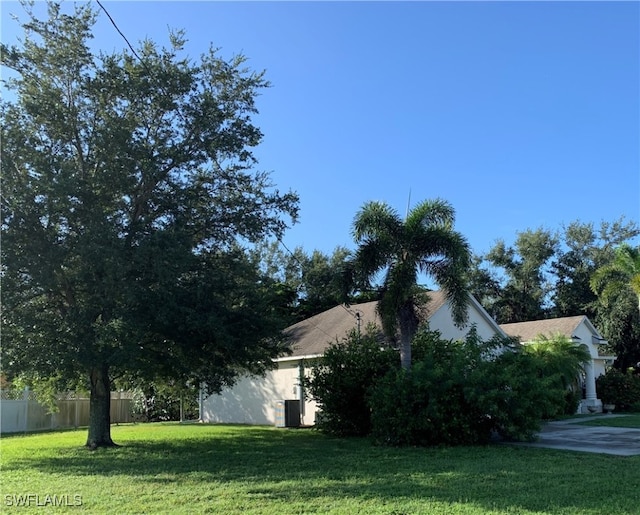 view of side of property with a yard