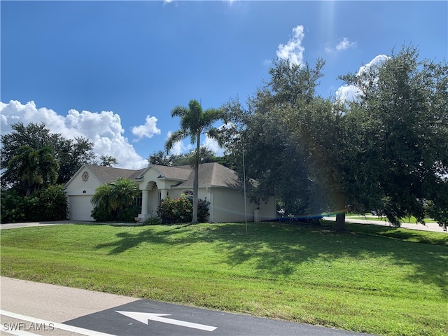 view of front of house featuring a garage and a front lawn