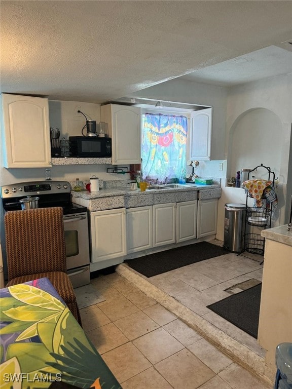 kitchen featuring white cabinets, stainless steel range with electric cooktop, and a textured ceiling