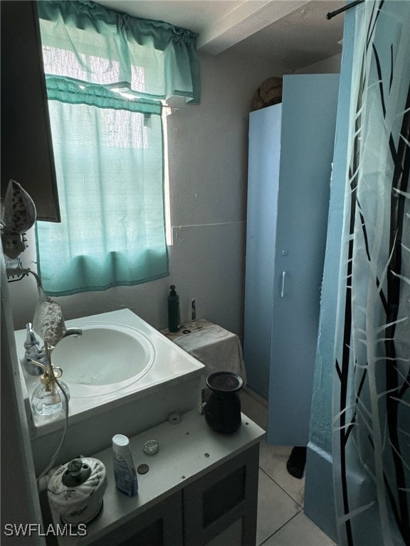 bathroom featuring tile patterned flooring and vanity