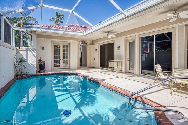 view of pool with a patio area, ceiling fan, and a lanai