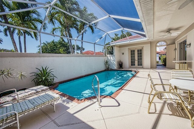 view of pool featuring french doors, a lanai, a patio area, and ceiling fan