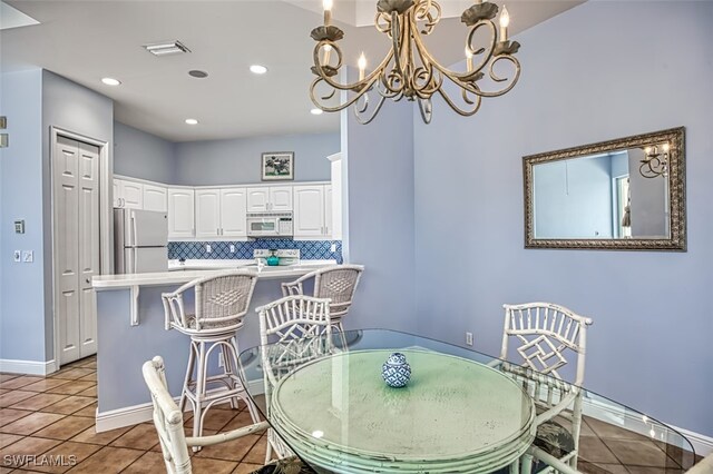 tiled dining area with a notable chandelier