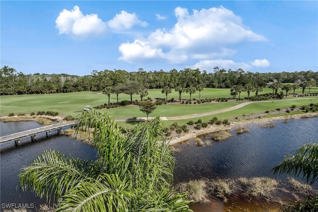 birds eye view of property featuring view of golf course and a water view