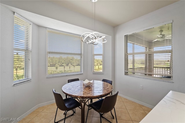 dining space with a chandelier and light tile patterned floors