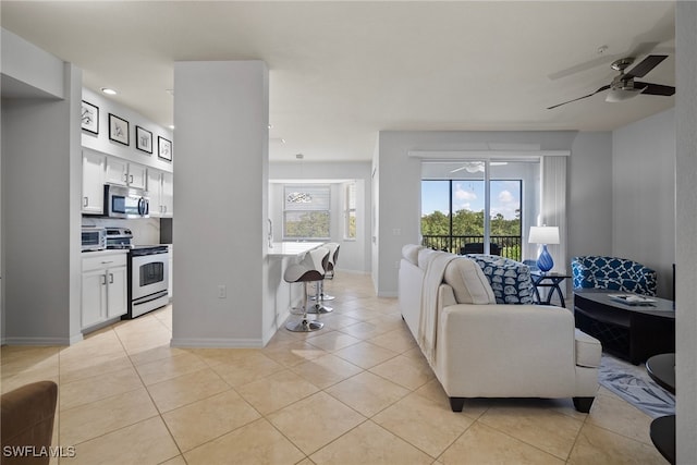 tiled living room featuring ceiling fan