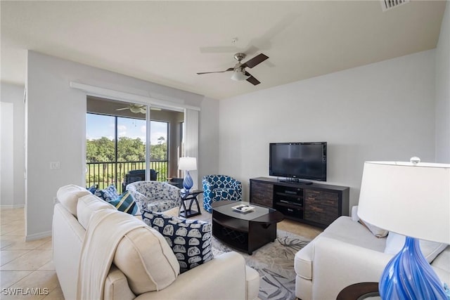 living room featuring a ceiling fan, visible vents, baseboards, and light tile patterned floors